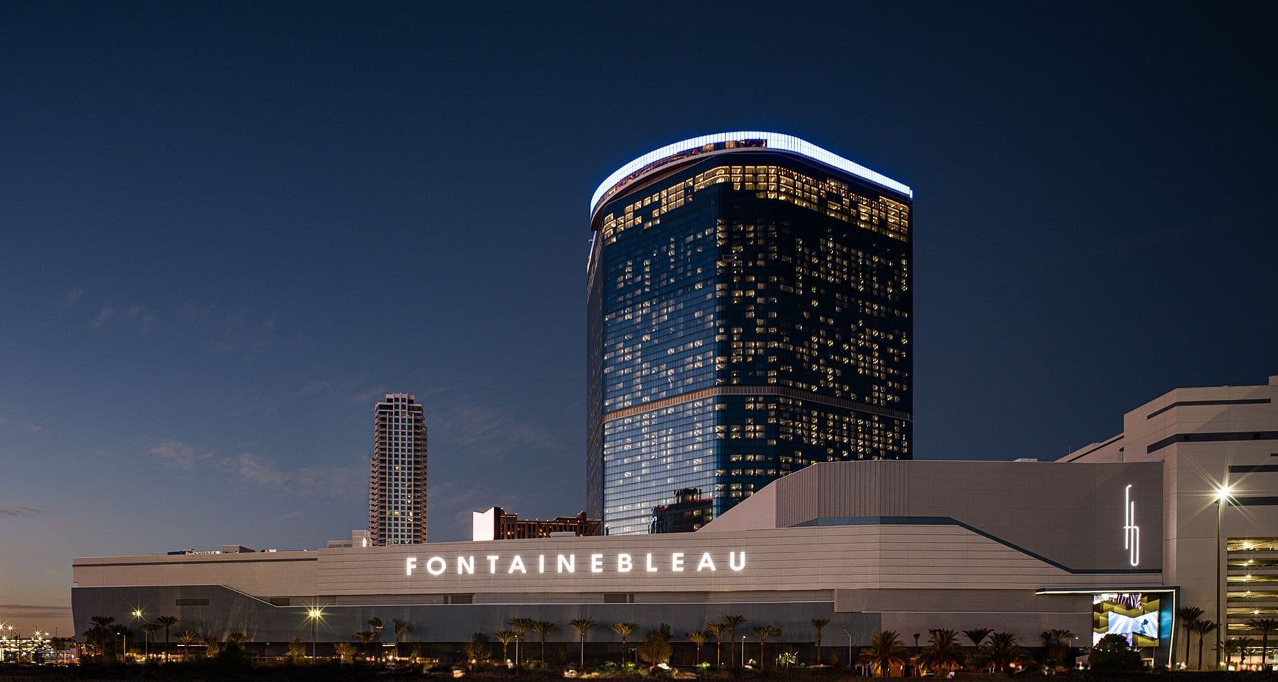 The illuminated Fontainebleau Las Vegas resort exterior at dusk