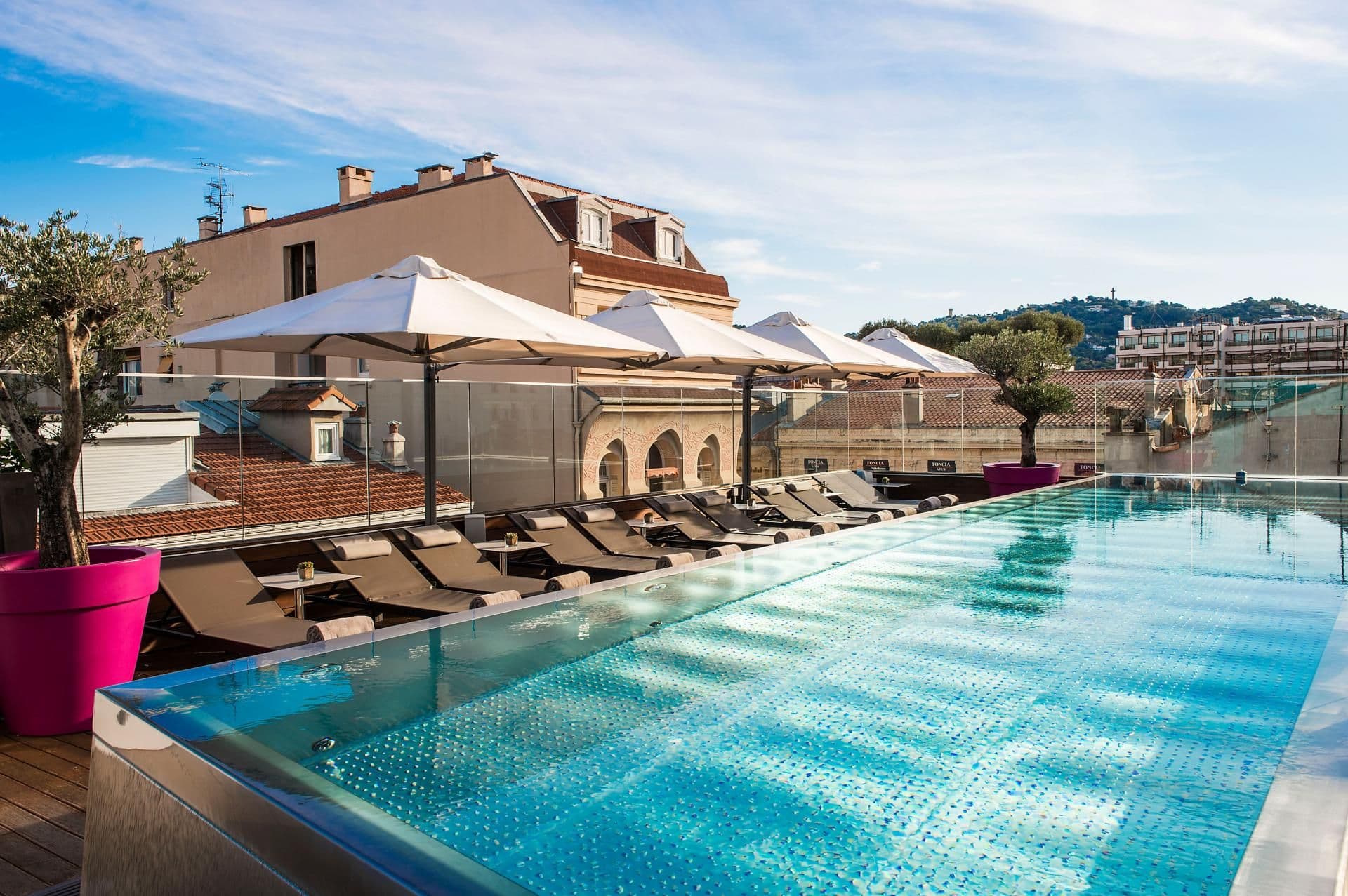Rooftop infinity pool, a unique corporate event venue with sun loungers and city views in Cannes, France.