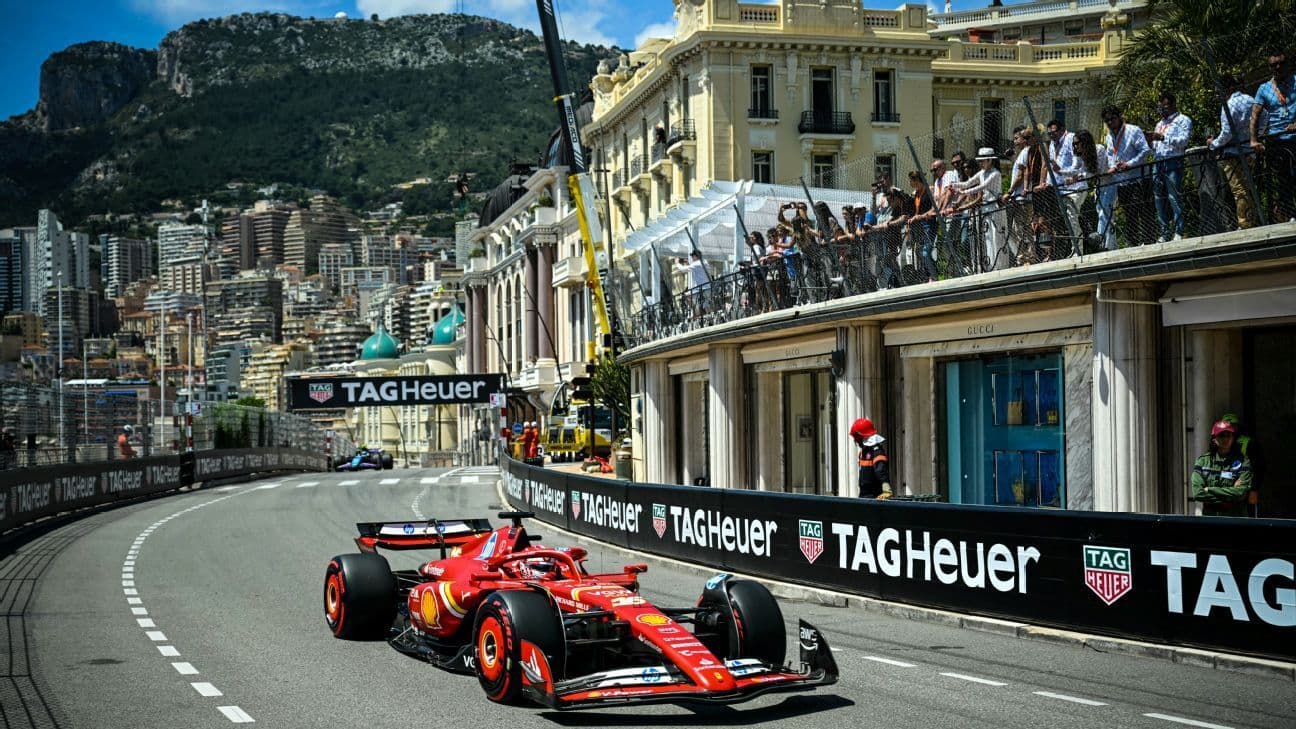 Red Formula 1 car races through Monaco's iconic street circuit
