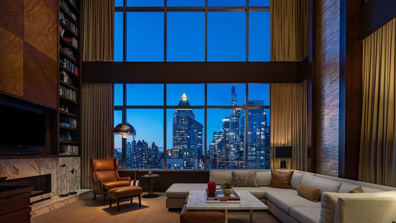 Elegant corporate event space with a panoramic New York City skyline view, ideal for executive offsites.