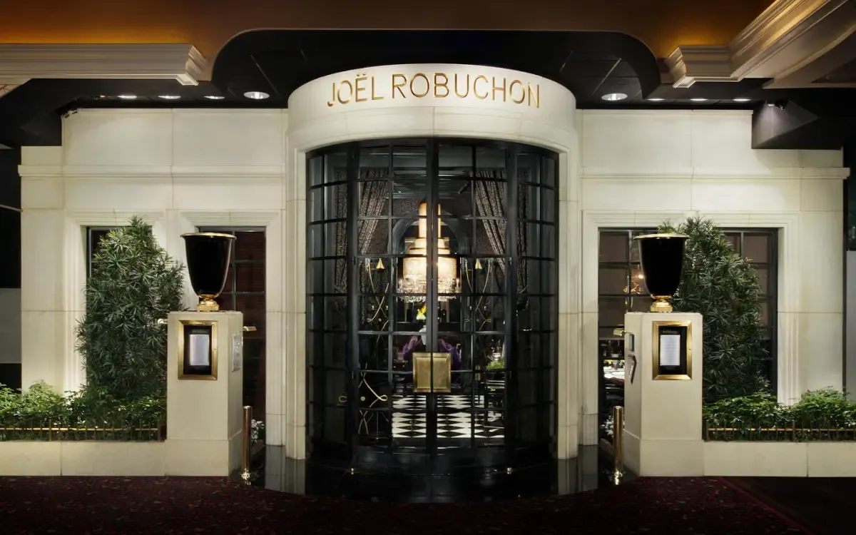 Elegant entrance of Joël Robuchon, a high-end privatised restaurant venue with grand glass doors and upscale