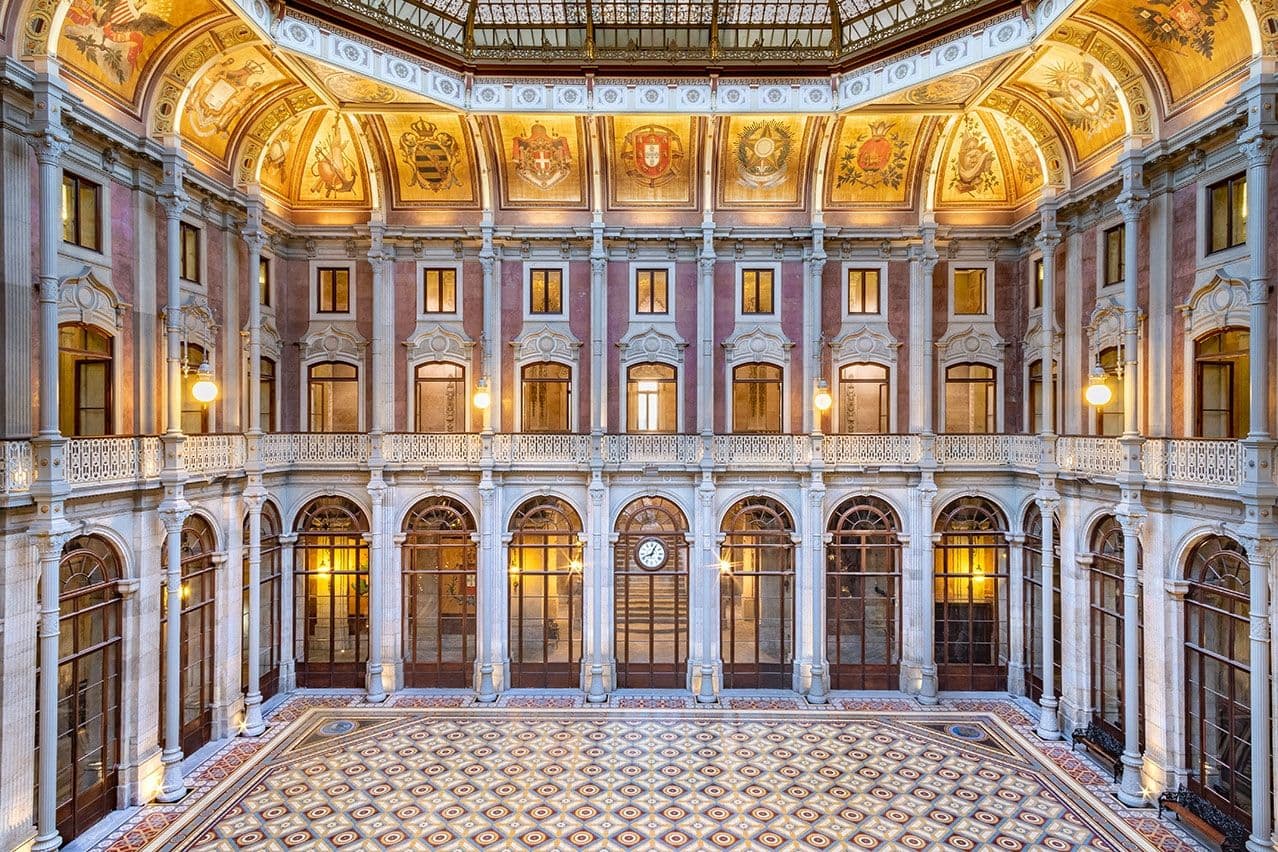 Ornate historic corporate event venue atrium in Lisbon, featuring balconies, arched windows