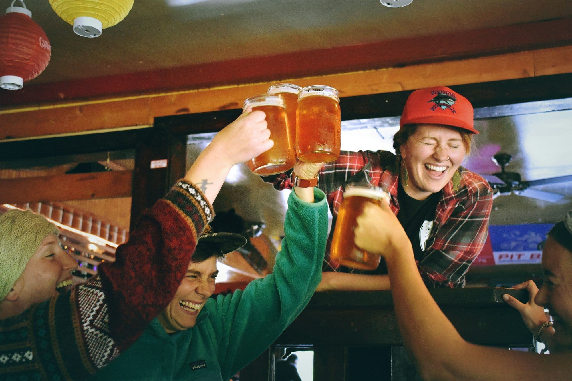 Team members cheering and clinking beer mugs at an Oktoberfest party