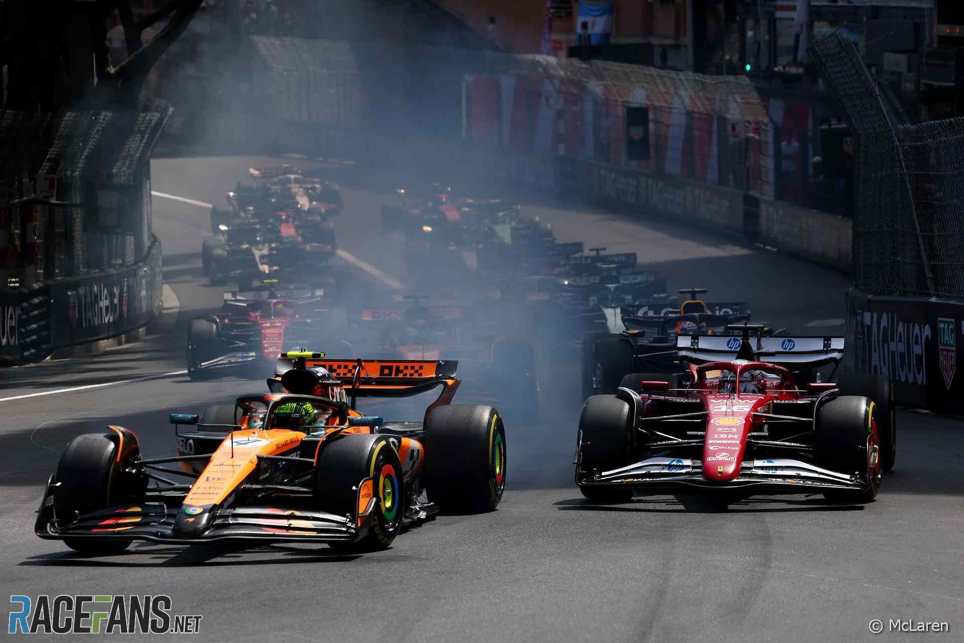Orange and red Formula 1 cars race closely on a track, a thrilling scene for an enterprise event.