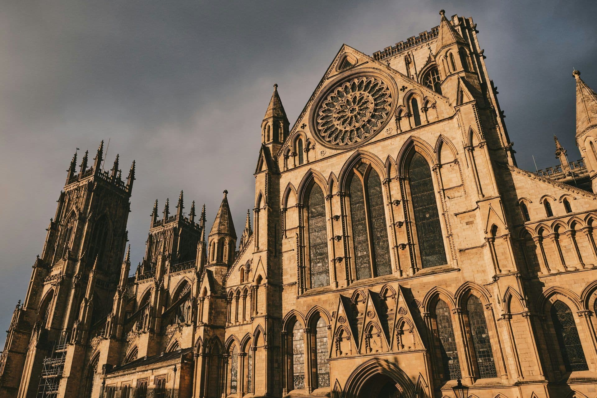 The grand Gothic architecture of York Minster, a historic venue in York, England, under a cloudy sky.