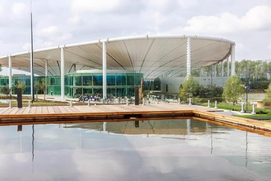 Modern corporate event venue with a large outdoor terrace, reflective pool