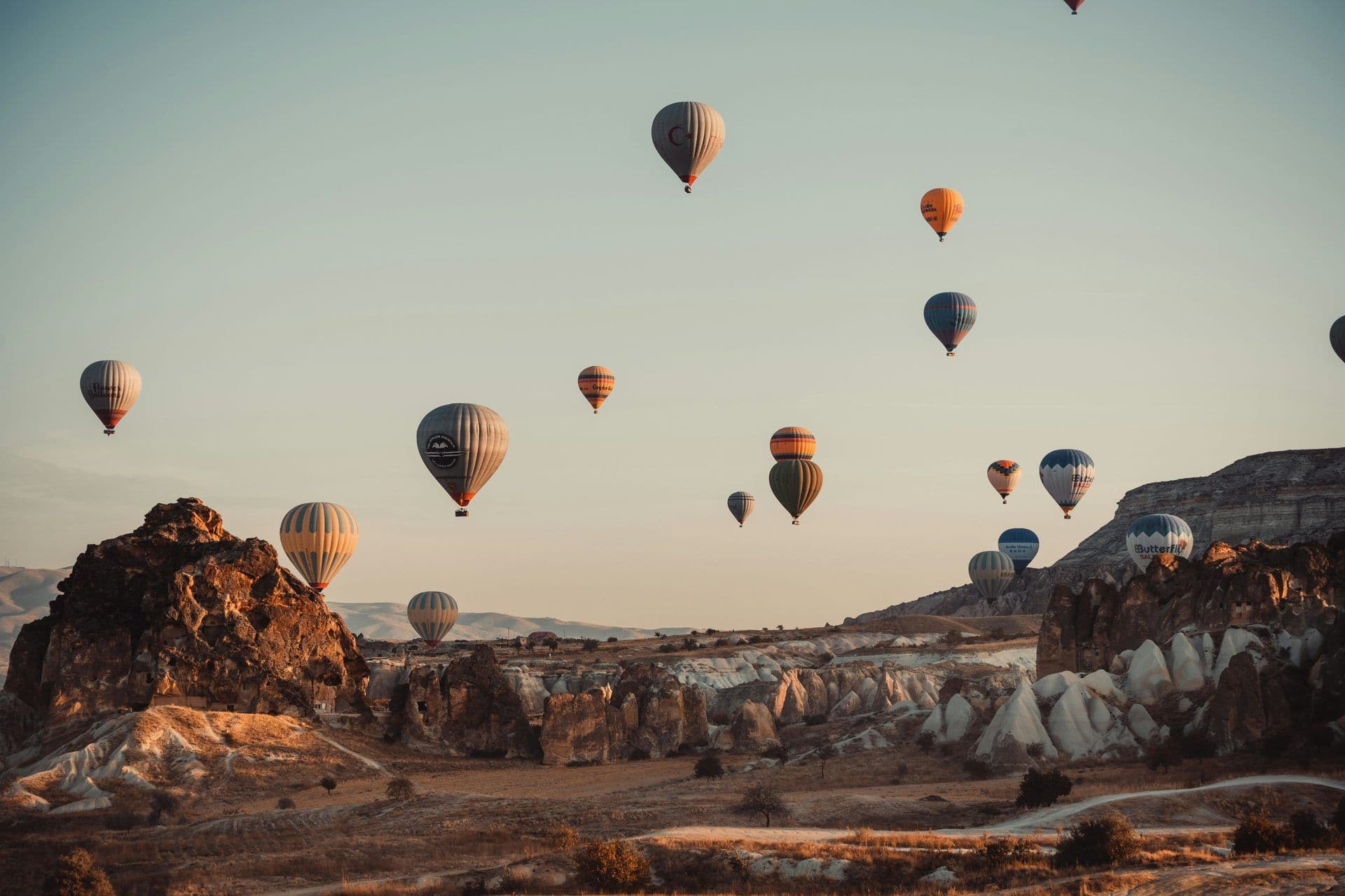 Many hot air balloons soar over Cappadocia's unique rock formations, ideal for an incentive trip.
