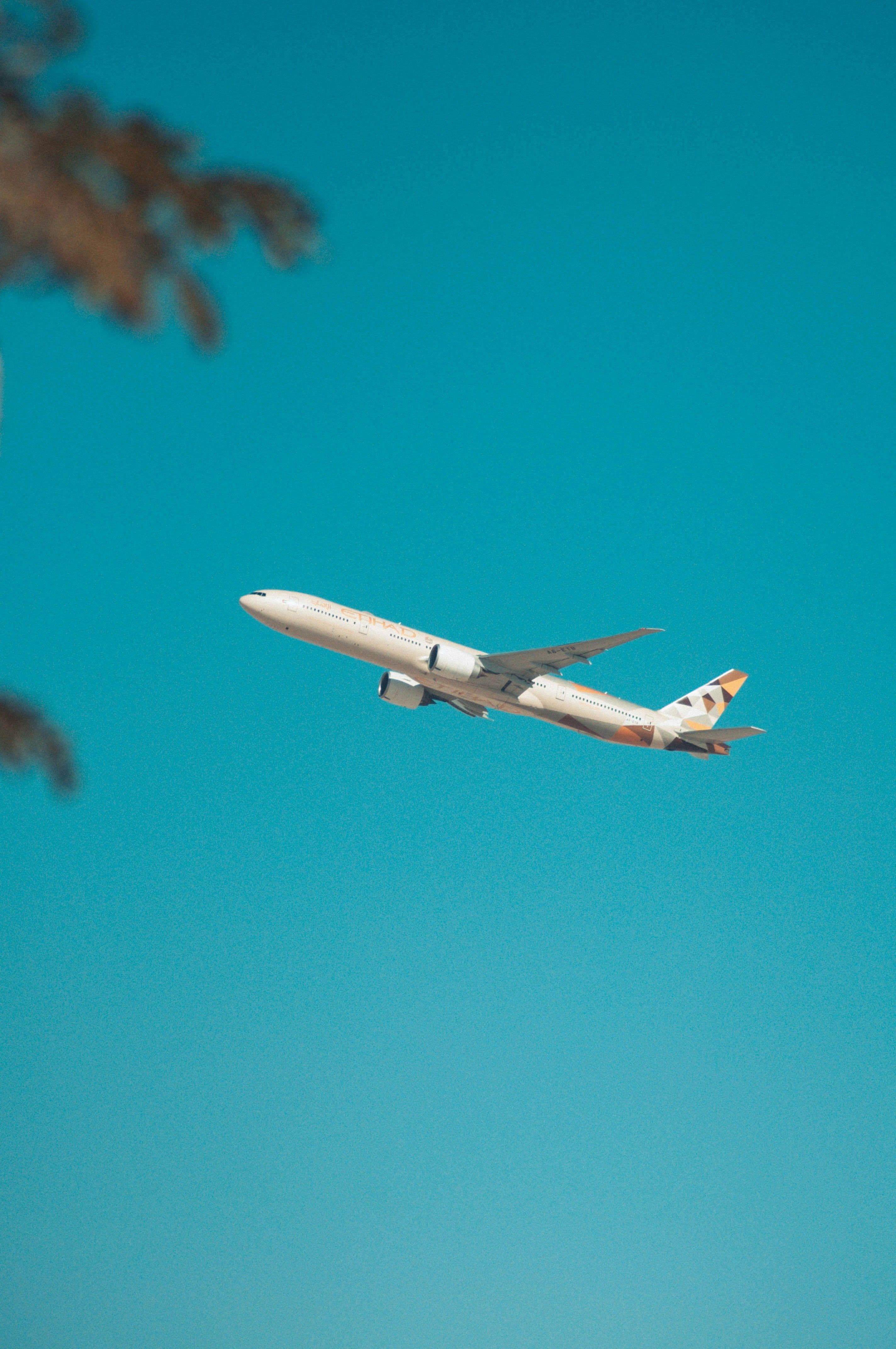 Commercial airliner climbing into a blue sky